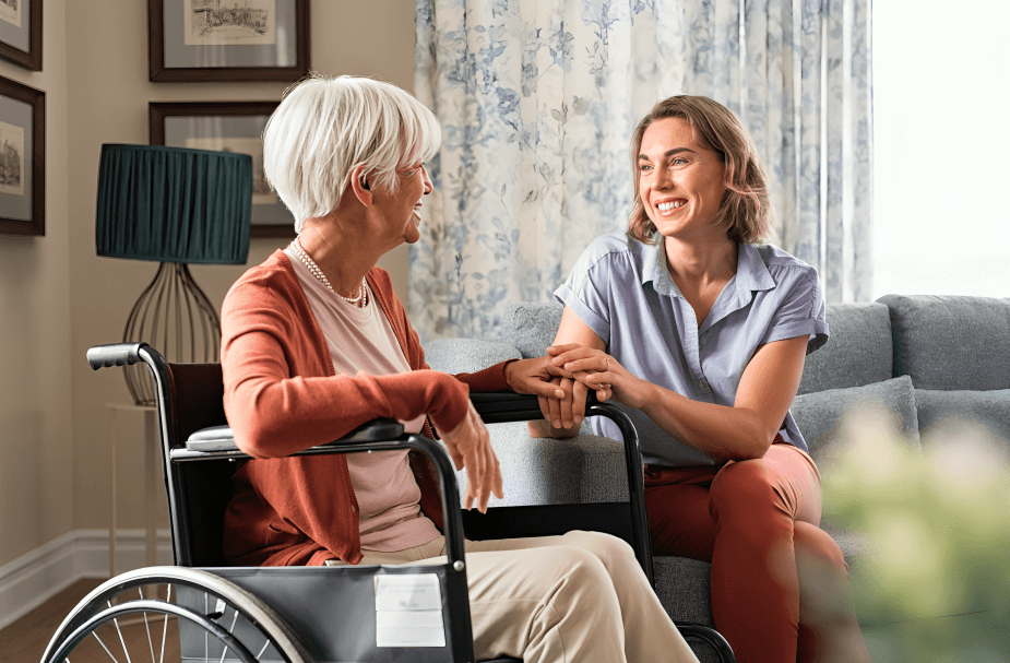 Two women, one in a wheelchair, smiling and talking.