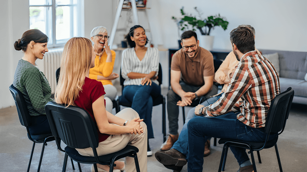 Diverse group of people in a supportive circle.