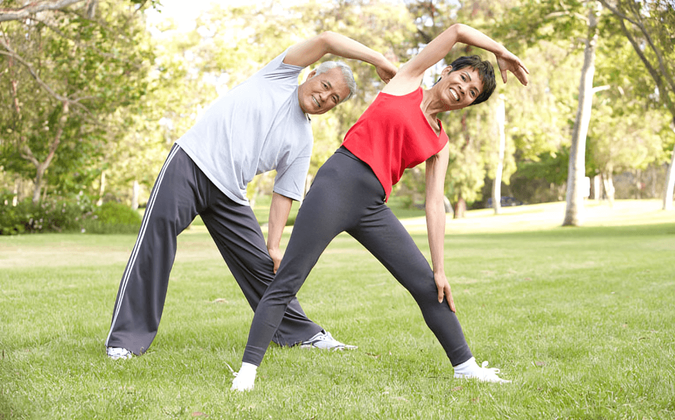 Perhaps a mature couple enjoys outdoor stretching exercises.