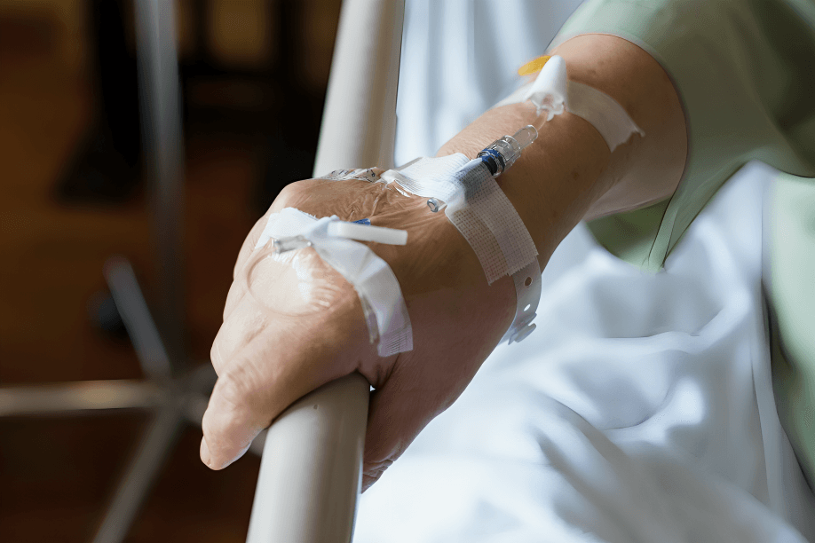 Close-up of a patient's hand with an IV.