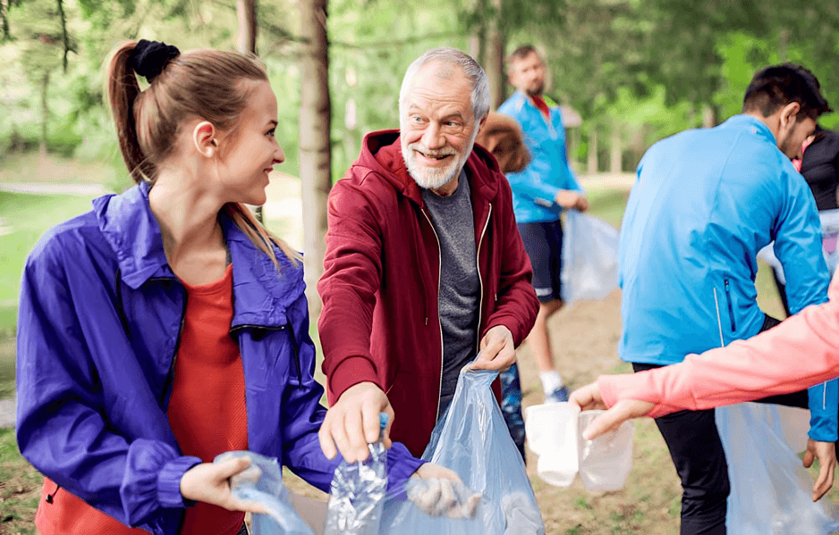 People collecting litter in a park together.