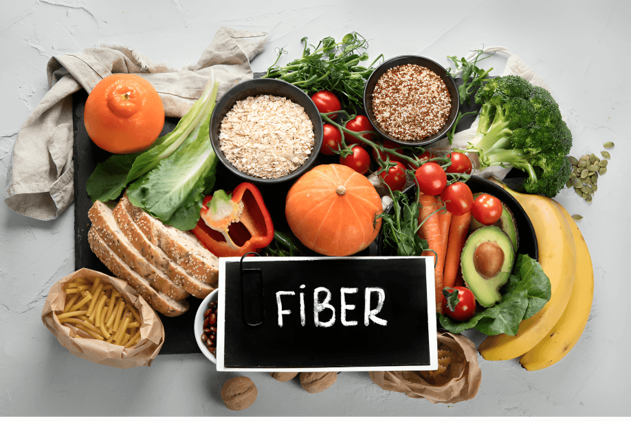 Assortment of high-fiber foods surrounding a "FIBER" sign.