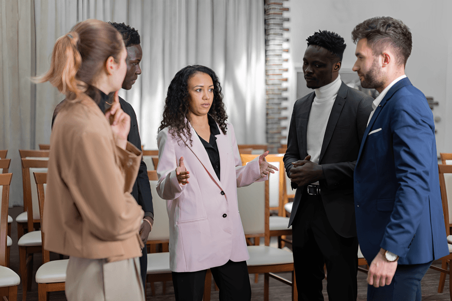 A diverse group of young professionals in a discussion.